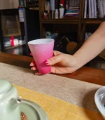 Holding a ceramic coffee cup