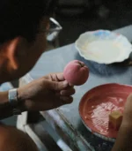 teacher gift-artisan hand-painting glaze onto a ceramic apple