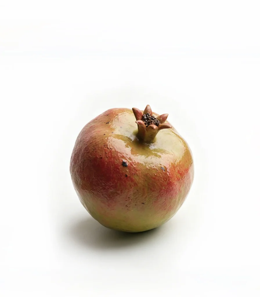 Hand-sculpted ceramic pomegranate dining table centerpiece by Jingee