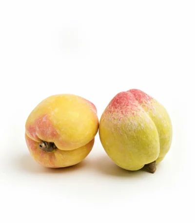 coffee table decor ideas-lifelike porcelain peach with a red blush and velvety finish