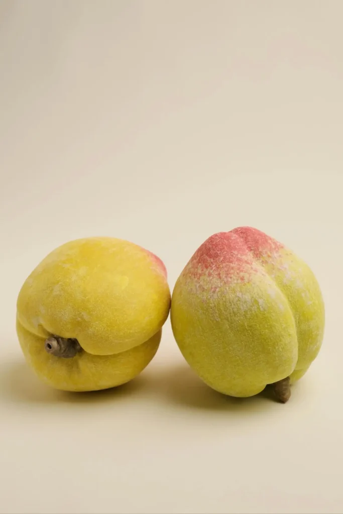 Porcelain peaches styled on a table as coffee table decor