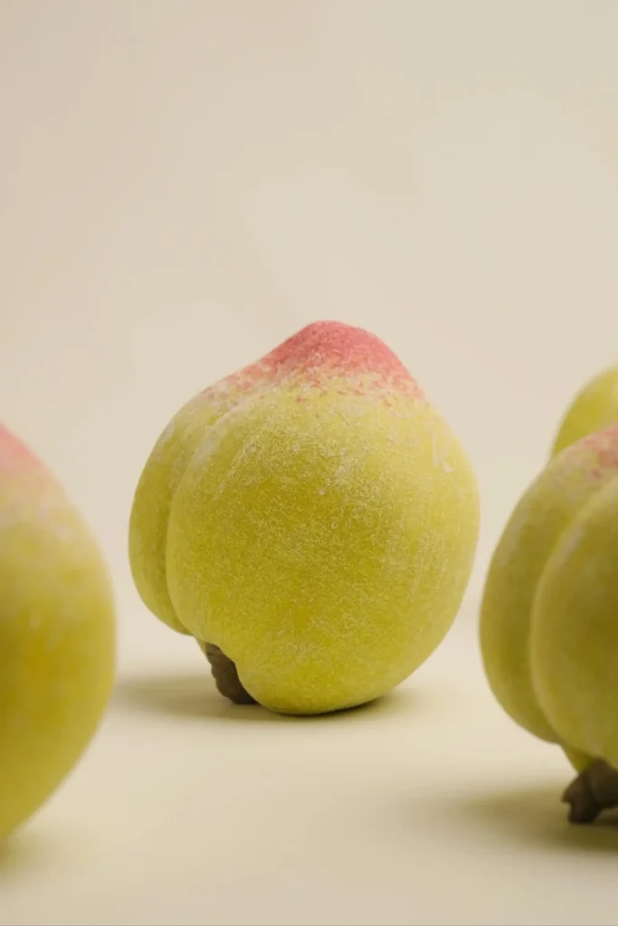 Porcelain peaches styled on a table as coffee table decor 02