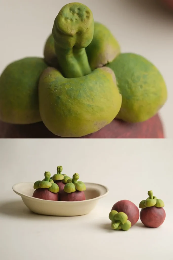 ceramic fruit decor-top-view image of a single ceramic mangosteen and a display of five ceramic mangosteen ornaments.